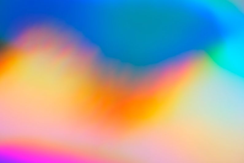 Color Genetics - a blurry image of a rainbow colored background