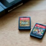 Racing Legend - a couple of nintendo games sitting on top of a wooden table