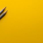 Creative Training - two gray pencils on yellow surface