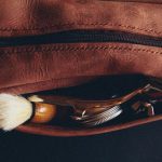 Grooming Kit - a leather pouch with a shaving brush and a razor in it
