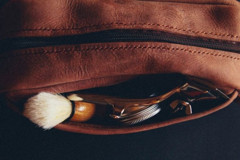 Grooming Kit - a leather pouch with a shaving brush and a razor in it