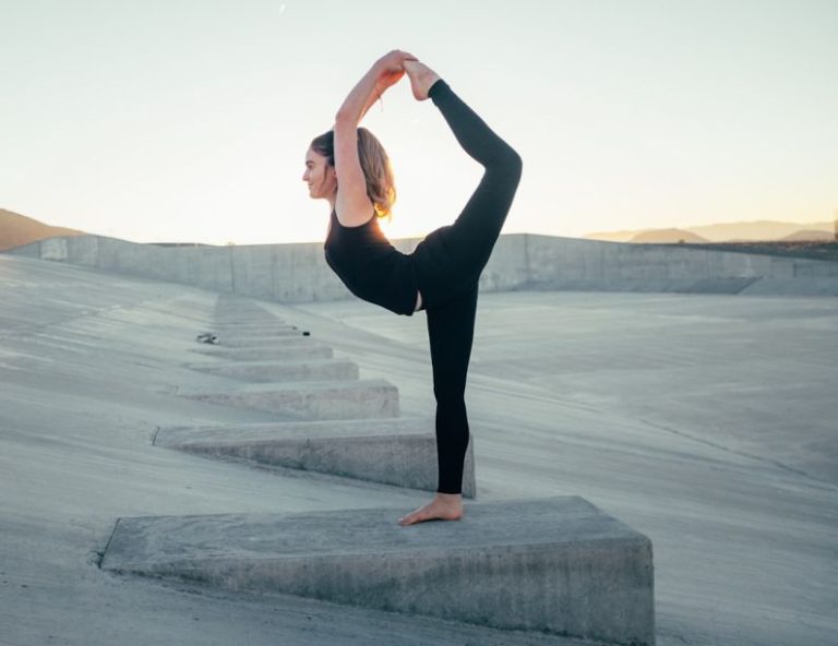 Flexibility Riding - shallow focus photo of woman in black sleeveless shirt doing yoga