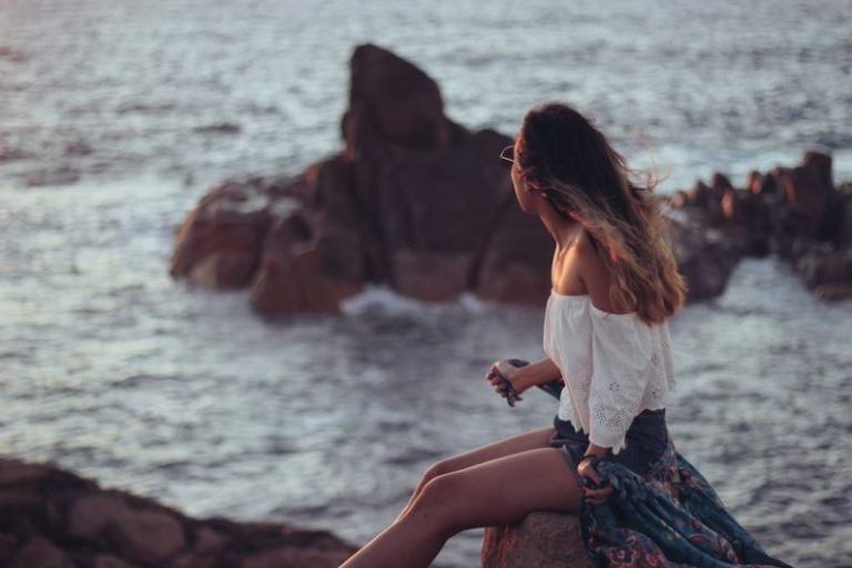 Meditation Riding - woman in white top sitting near body of water